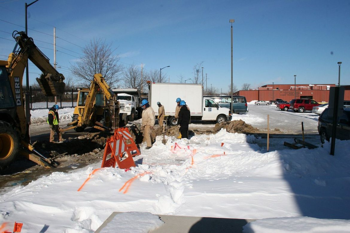 workers repairing an underground water pipe